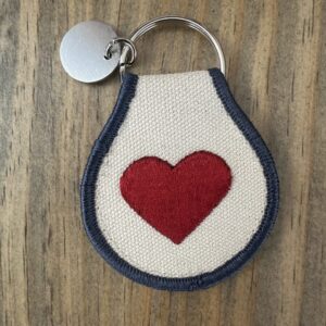 White keychain with a red heart.