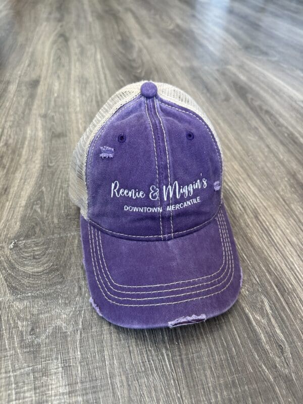 Purple distressed baseball cap with logo.