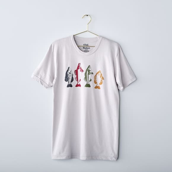 White t-shirt with four colorful fish.