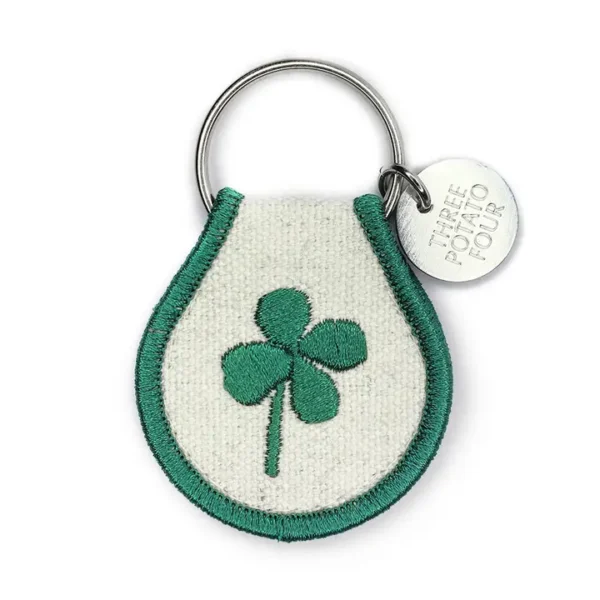 Green shamrock keychain with "Three Potato Four" tag.