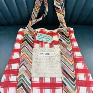 Red and white plaid tote bag with chevron straps.