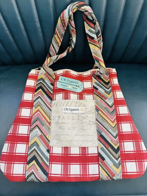 Red and white plaid tote bag with chevron straps.