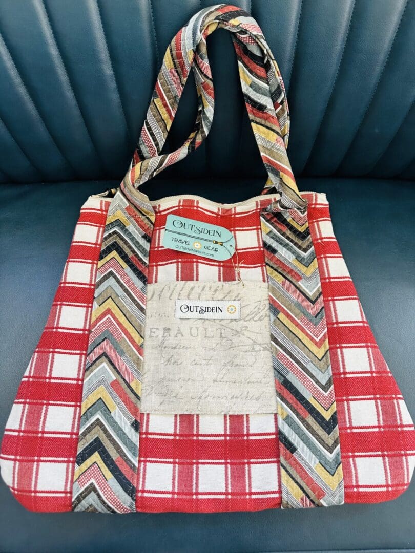 Red and white plaid tote bag with chevron straps.