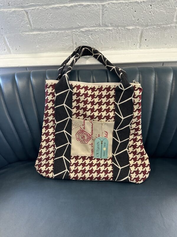 Houndstooth tote bag with black accents.