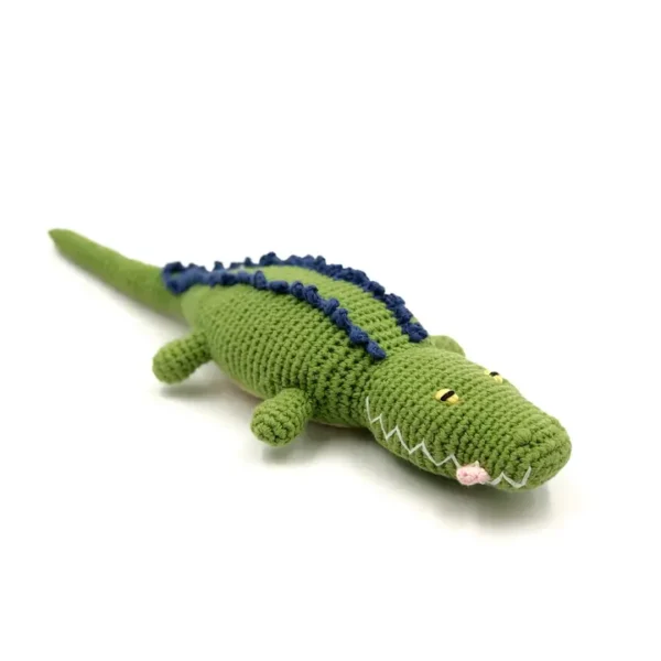 Green crocheted alligator toy on white background.