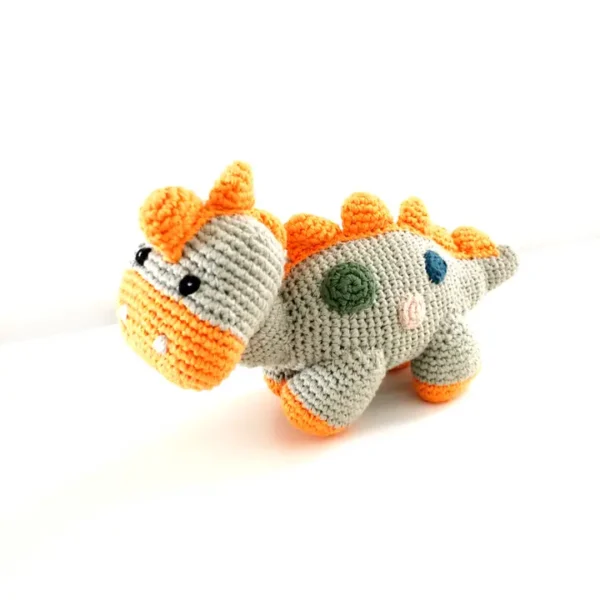 Crocheted gray dinosaur with orange accents.