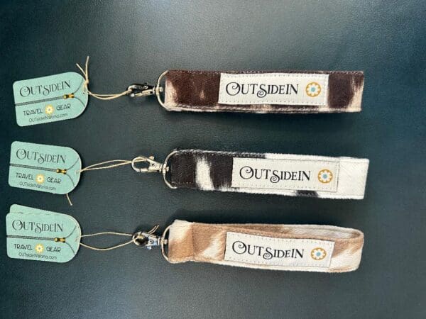 Three cowhide keychain straps with "OutsiDein" logo.