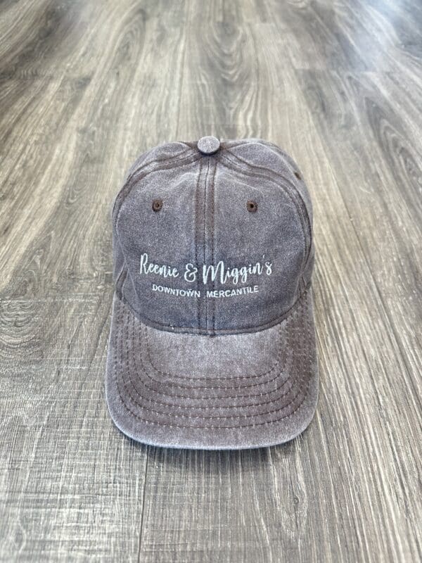 Gray baseball cap with "Reenie & Muggin's" logo.