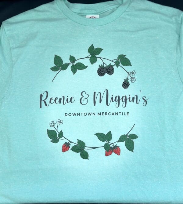 Light blue shirt with Reenie & Miggin's logo.