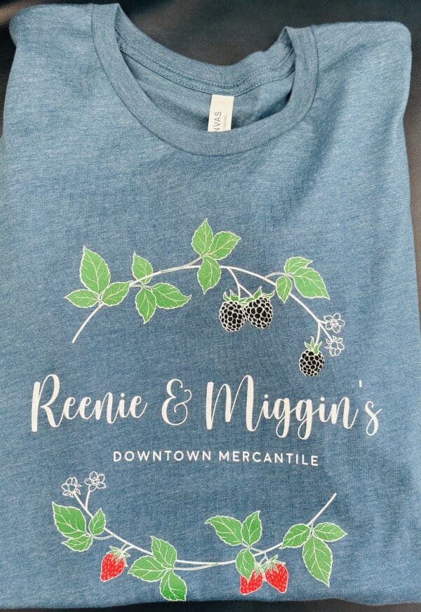 Blue t-shirt with Reenie & Miggin's logo.