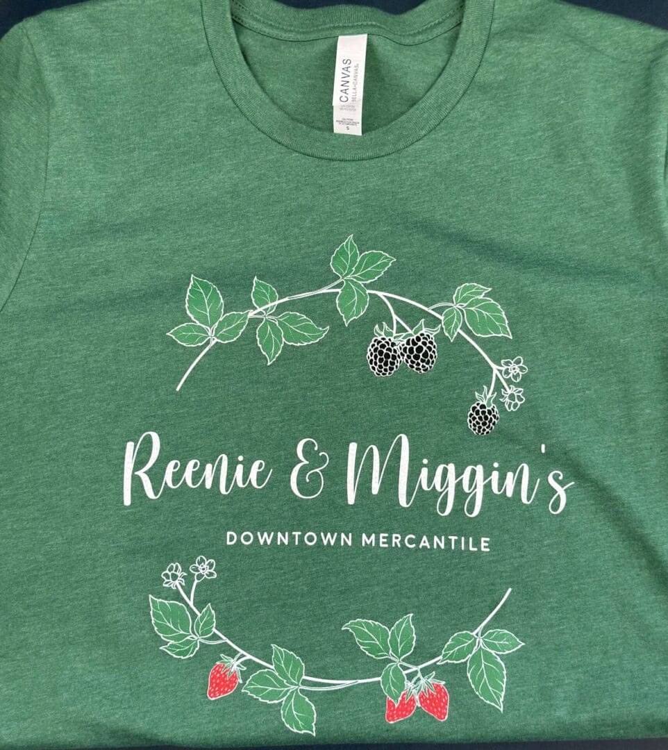 Green t-shirt with Reenie & Miggin's logo.