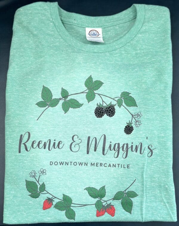 Green t-shirt with "Reenie & Miggin's" logo.