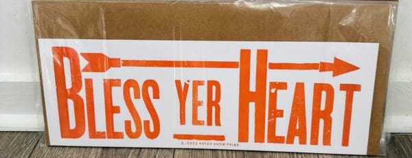 Orange "Bless Yer Heart" print with arrow.