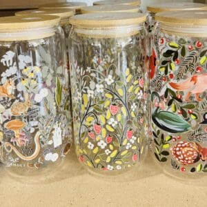 Glass jars with floral and animal designs.