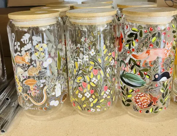 Glass jars with floral and animal designs.