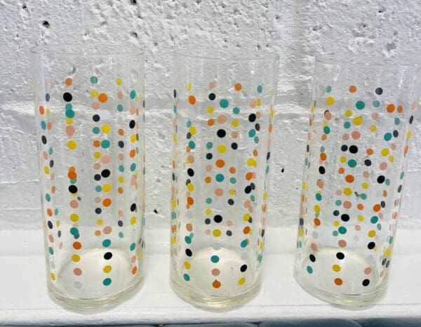 Three glasses with colorful polka dots.