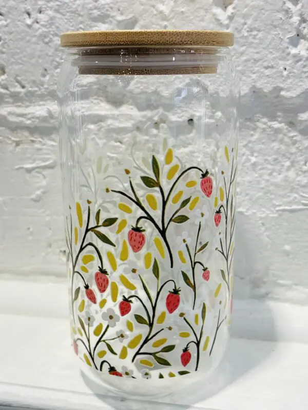 Glass jar with strawberry print and bamboo lid.